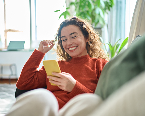 woman on sofa looking at phone